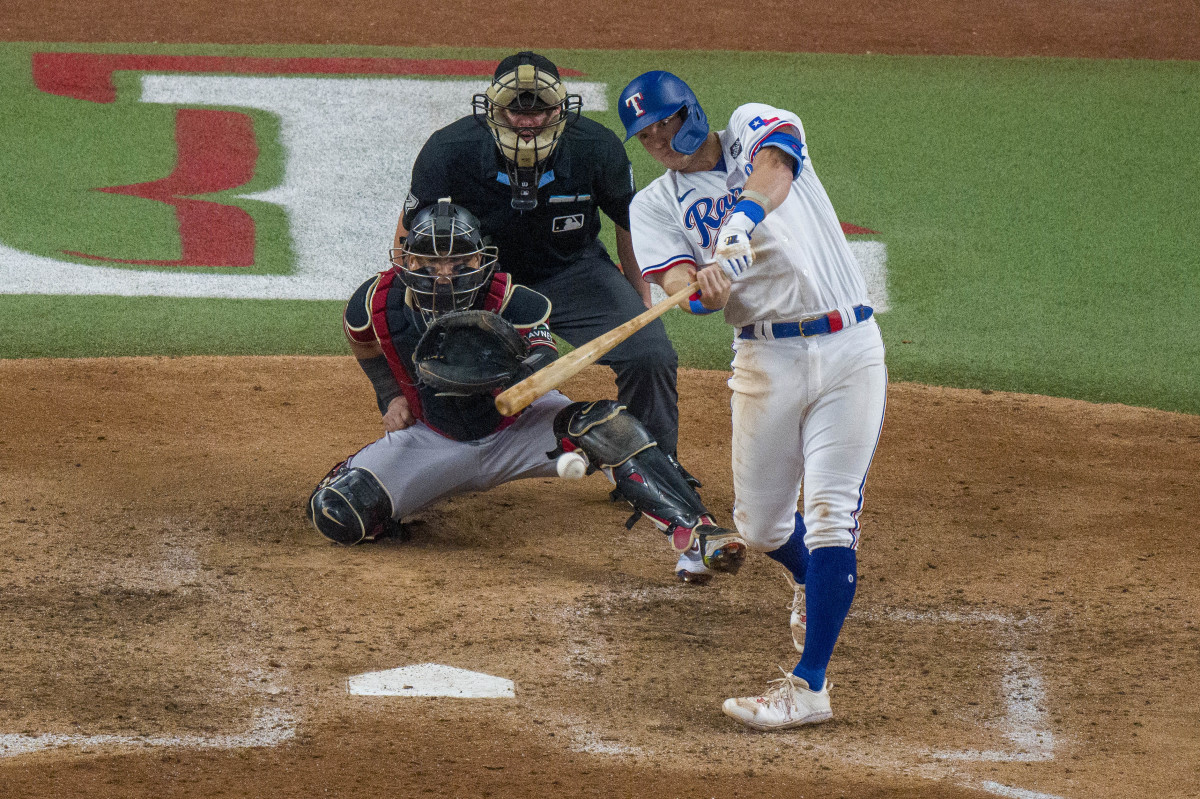 Oct 27, 2023; Arlington, Texas, USA; Texas Rangers third baseman Josh Jung (6) hits a single against the Arizona Diamondbacks during the sixth inning in game one of the 2023 World Series at Globe Life Field. Mandatory Credit: Jerome Miron-USA TODAY Sports